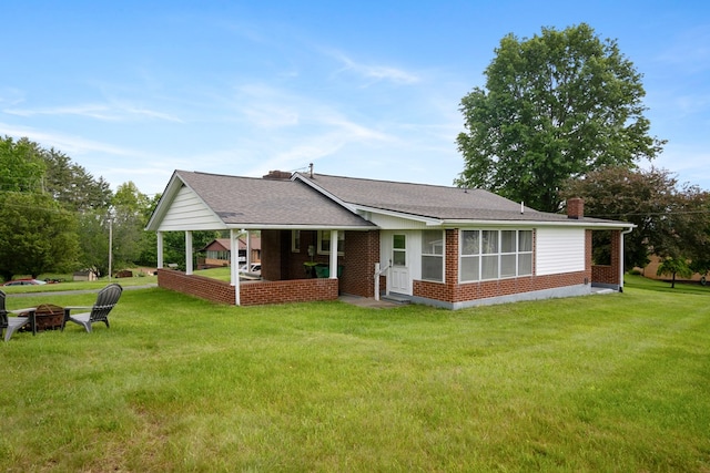 411 Courtland Cir, Galax, VA 24333 - view of front of house with a fire pit, a chimney, brick siding, and a front yard
