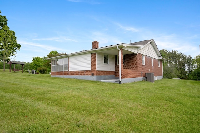 411 Courtland Cir, Galax, VA 24333 - view of side of home featuring a chimney, brick siding, central AC, and a lawn
