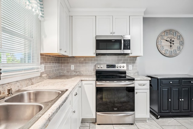 411 Courtland Cir, Galax, VA 24333 - kitchen featuring appliances with stainless steel finishes, crown molding, white cabinetry, and backsplash