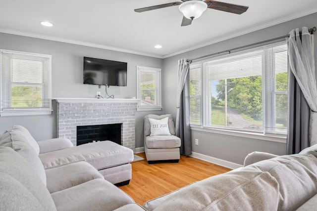 411 Courtland Cir, Galax, VA 24333 - living area featuring crown molding, a ceiling fan, wood finished floors, a fireplace, and baseboards
