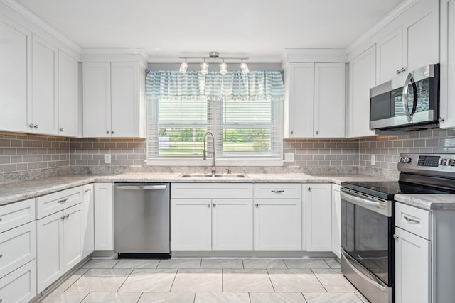 411 Courtland Cir, Galax, VA 24333 - kitchen featuring stainless steel appliances, a sink, white cabinets, backsplash, and ornamental molding