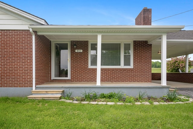 411 Courtland Cir, Galax, VA 24333 - view of exterior entry with brick siding, a porch, a chimney, and a yard