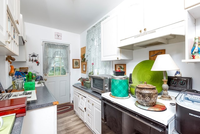 210 Valley St NE, Abingdon, VA 24210 - kitchen featuring under cabinet range hood, white cabinetry, light wood-style floors, and dark countertops