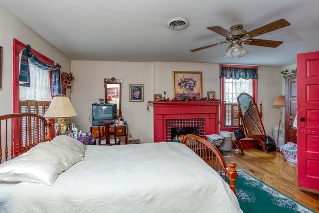210 Valley St NE, Abingdon, VA 24210 - bedroom with wood finished floors, a fireplace, and a ceiling fan