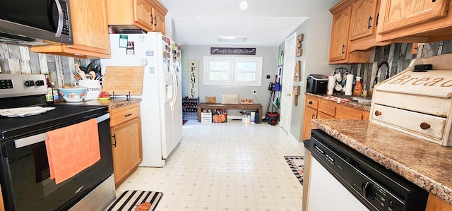 kitchen featuring light stone counters and stainless steel appliances