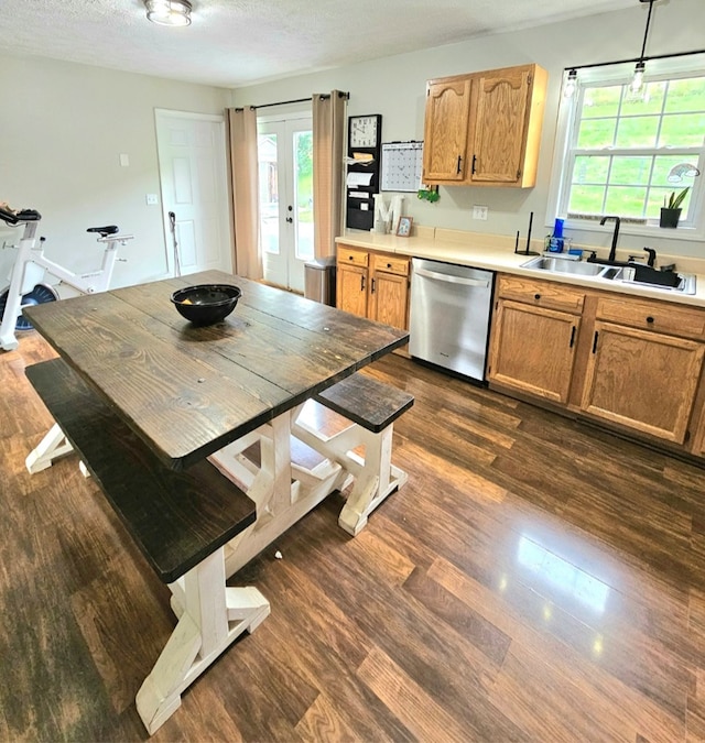 kitchen with dishwasher, light countertops, a sink, dark wood-style flooring, and french doors