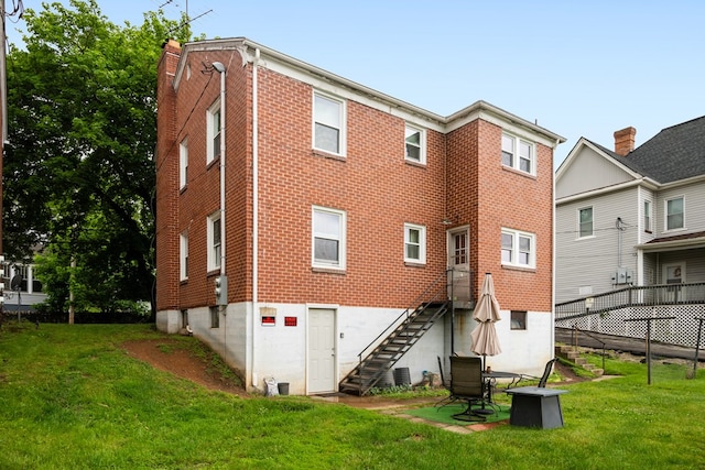 222 Randolph Ave, Pulaski, VA 24301 - back of house with stairs, a yard, and brick siding