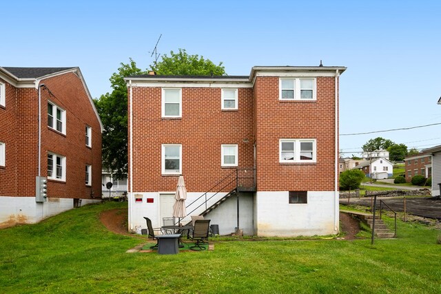 222 Randolph Ave, Pulaski, VA 24301 - back of property with a yard, stairway, and brick siding