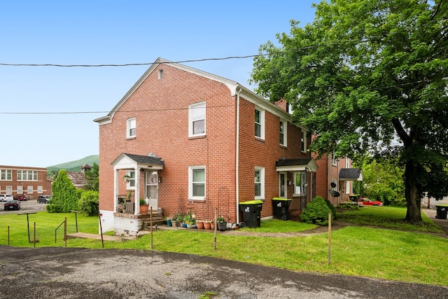 222 Randolph Ave, Pulaski, VA 24301 - rear view of house with a lawn, brick siding, and a chimney