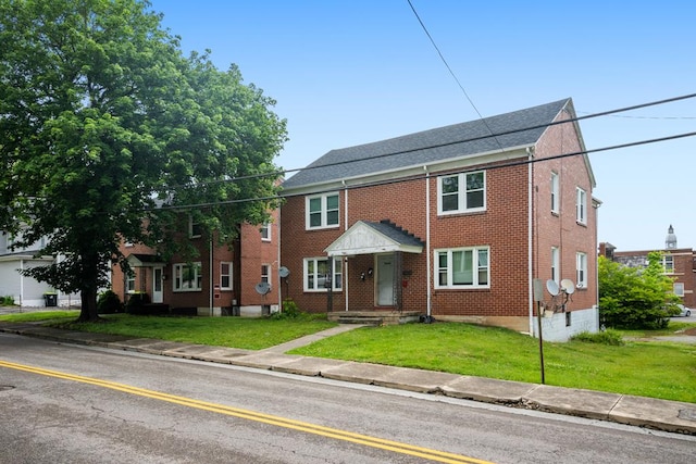 222 Randolph Ave, Pulaski, VA 24301 - view of property with brick siding and a front yard