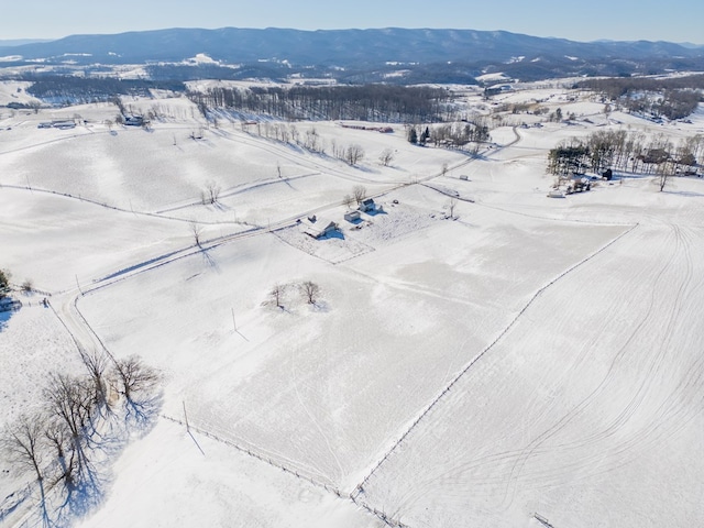 snowy aerial view with a mountain view