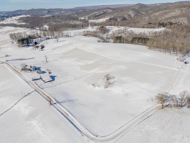 snowy aerial view featuring a mountain view