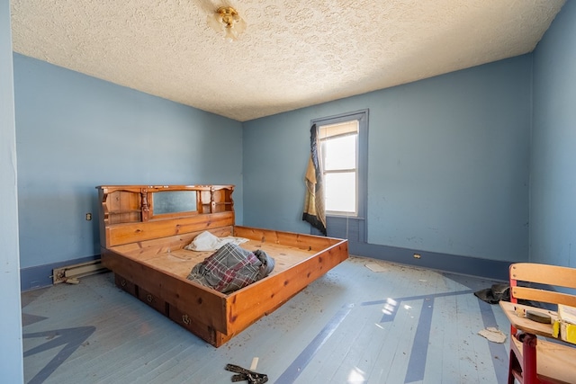 bedroom with hardwood / wood-style flooring and a textured ceiling