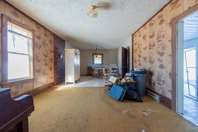 misc room with light carpet and a textured ceiling