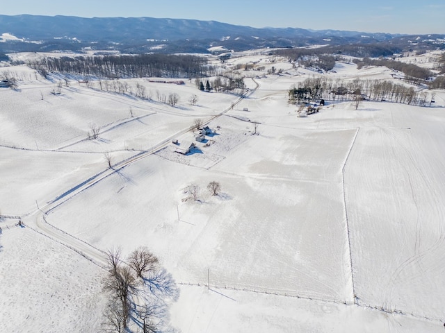 snowy aerial view featuring a mountain view