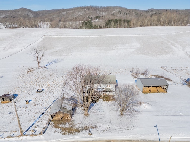 snowy aerial view featuring a mountain view