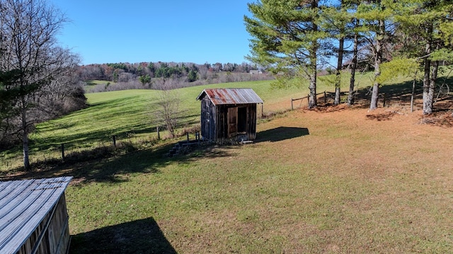 view of yard with a rural view and a shed