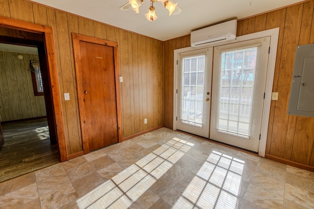 doorway to outside with a wall unit AC, electric panel, french doors, and wood walls