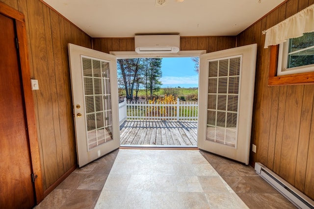 entryway with french doors, a baseboard radiator, wooden walls, and a wall mounted AC