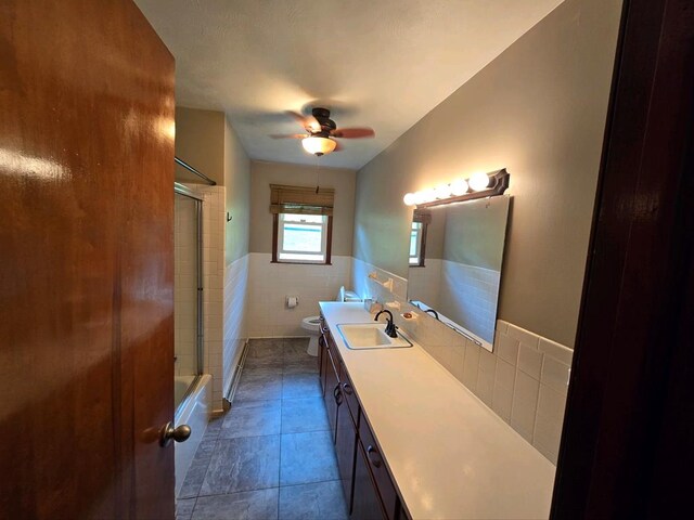 128 Roberts Chapel Rd, Saltville, VA 24370 - bathroom with tile walls, toilet, ceiling fan, vanity, and tile patterned floors