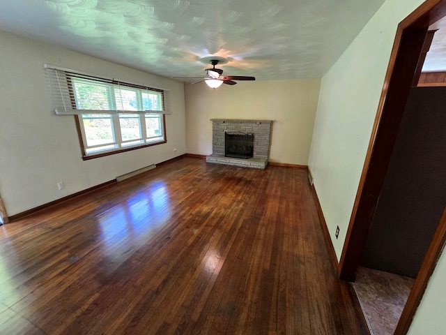 128 Roberts Chapel Rd, Saltville, VA 24370 - unfurnished living room featuring a ceiling fan, wood finished floors, baseboards, and a stone fireplace