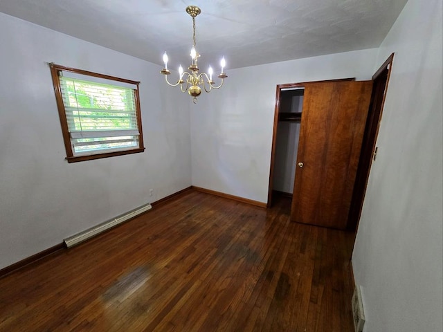 128 Roberts Chapel Rd, Saltville, VA 24370 - unfurnished bedroom featuring baseboard heating, a chandelier, dark wood-type flooring, and baseboards