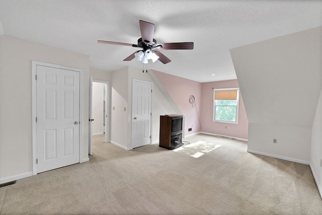18959 Middle Dr, Abingdon, VA 24211 - unfurnished living room with a wood stove, a ceiling fan, and light colored carpet