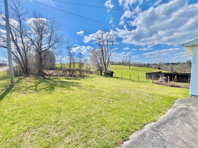 view of yard with a rural view