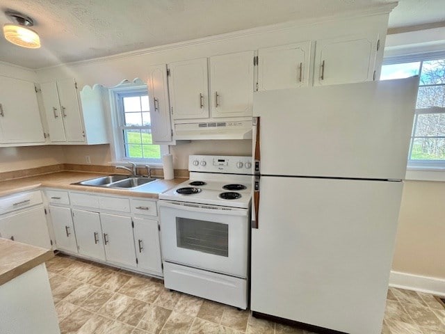 kitchen featuring white appliances, sink, a textured ceiling, and white cabinets