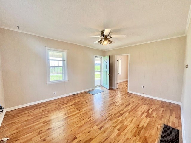 unfurnished room featuring light hardwood / wood-style flooring and ornamental molding