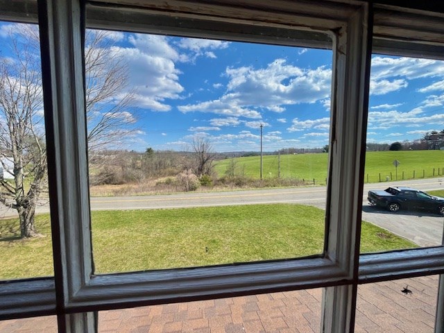 doorway to outside featuring a rural view