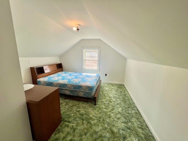 carpeted bedroom featuring lofted ceiling