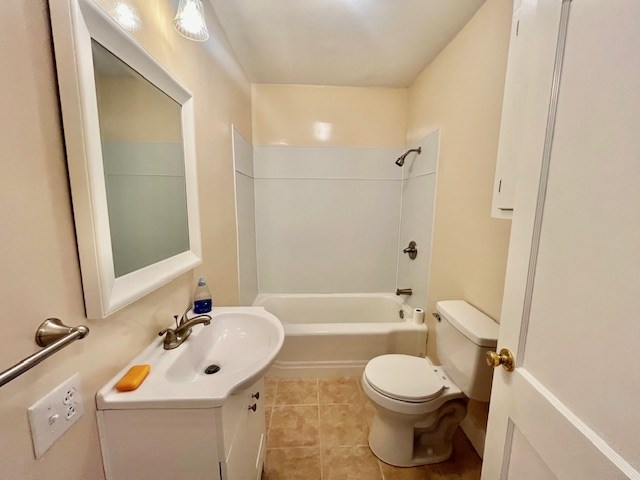 full bathroom with vanity, tile patterned flooring,  shower combination, and toilet