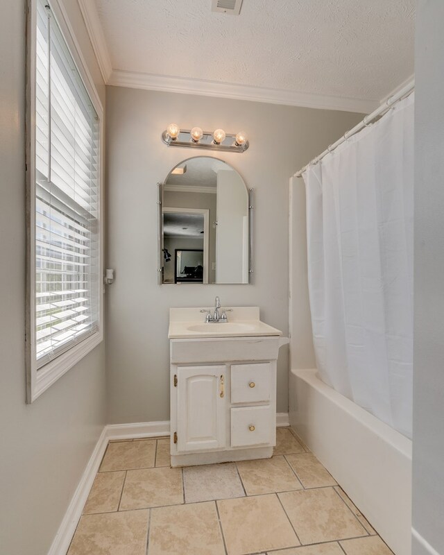 467 Thru Dr, Pounding Mill, VA 24637 - bathroom featuring ornamental molding, vanity, tile patterned floors, shower / bathtub combination with curtain, and a textured ceiling
