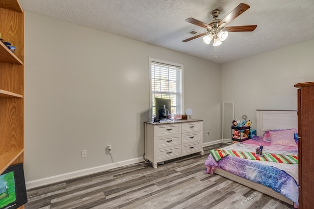 467 Thru Dr, Pounding Mill, VA 24637 - bedroom with wood finished floors, a ceiling fan, and a textured ceiling