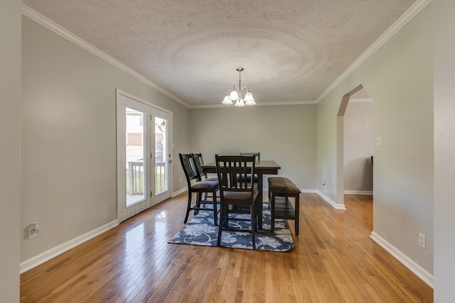 467 Thru Dr, Pounding Mill, VA 24637 - dining area with a textured ceiling, arched walkways, light wood-style flooring, a chandelier, and ornamental molding