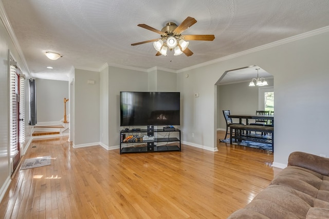 467 Thru Dr, Pounding Mill, VA 24637 - living room featuring light wood-style floors, arched walkways, a chandelier, ceiling fan, and crown molding