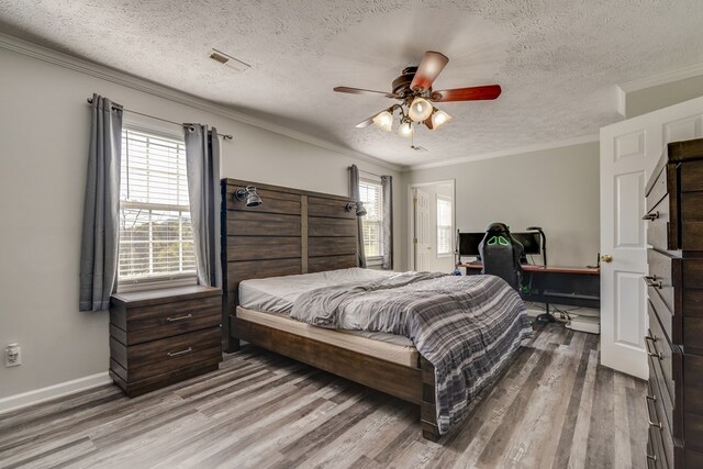 467 Thru Dr, Pounding Mill, VA 24637 - bedroom featuring a textured ceiling, wood finished floors, multiple windows, crown molding, and ceiling fan