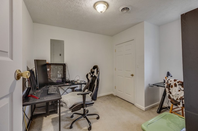 office area with a textured ceiling, electric panel, carpet floors, baseboards, and visible vents