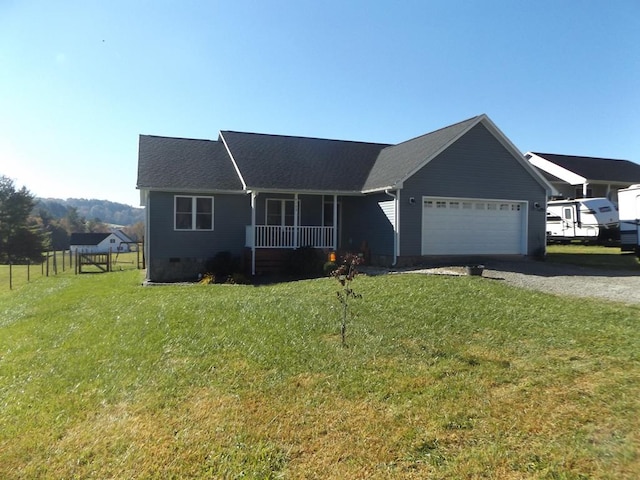 ranch-style home featuring a garage, a front yard, and covered porch