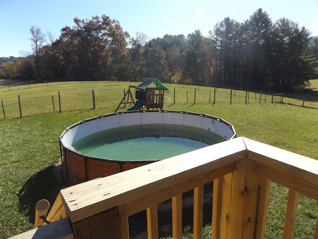 view of swimming pool featuring a rural view and a yard