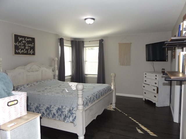 bedroom with dark hardwood / wood-style flooring