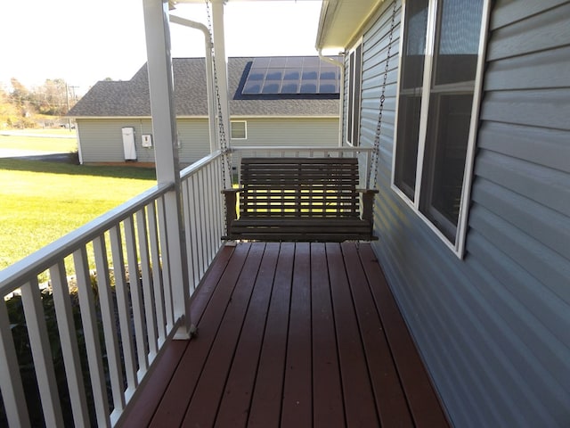 wooden deck featuring a yard