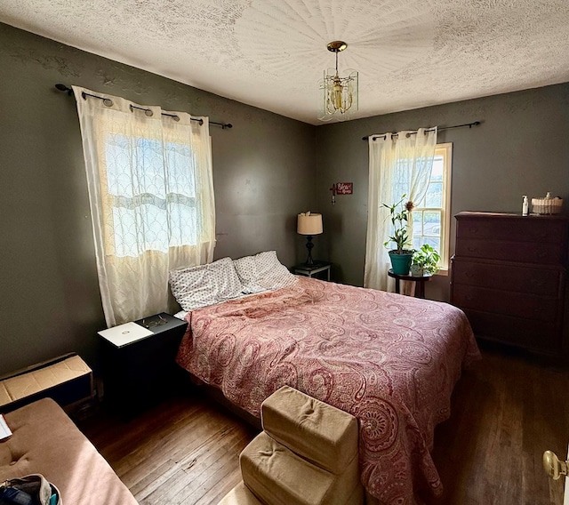 bedroom featuring wood-type flooring and a textured ceiling