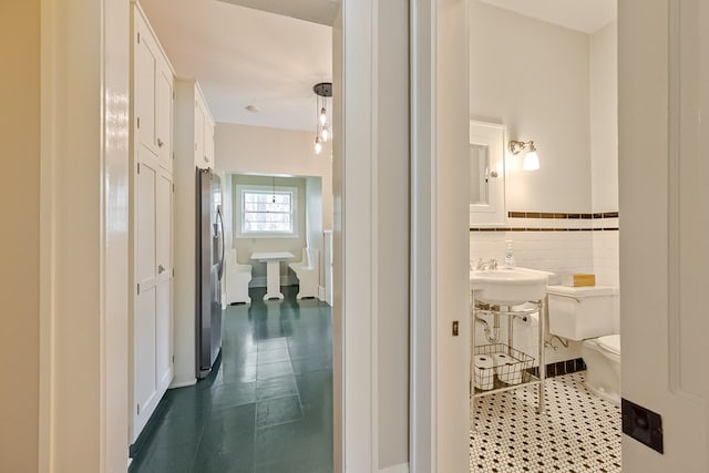 173 S Main St, Hillsville, VA 24343 - corridor with dark tile patterned floors and wainscoting