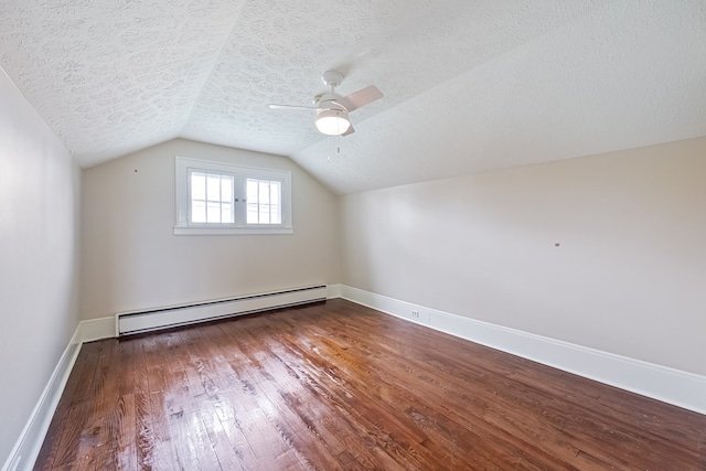 173 S Main St, Hillsville, VA 24343 - bonus room with baseboard heating, a textured ceiling, wood-type flooring, lofted ceiling, and baseboards