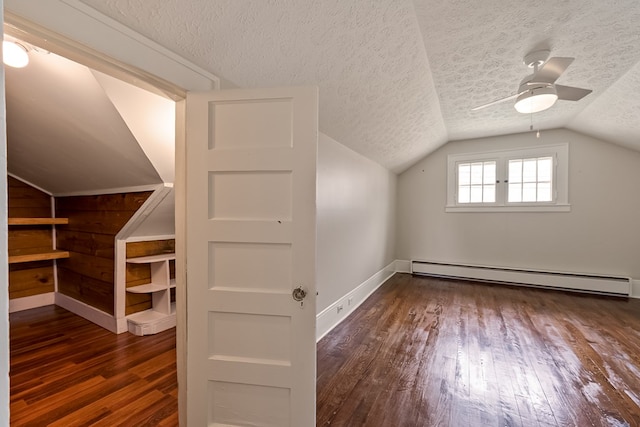173 S Main St, Hillsville, VA 24343 - additional living space featuring a baseboard radiator, wood-type flooring, lofted ceiling, a textured ceiling, and baseboards