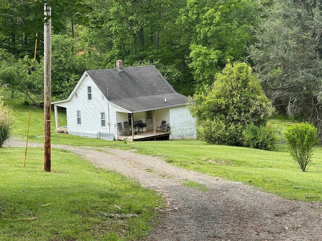 402 Dickerson Rd, Willis, VA 24343 - view of home's exterior with driveway, a yard, a wooden deck, and a chimney