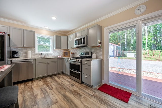 1610 Pope Rd, Ivanhoe, VA 24350 - kitchen with stainless steel appliances, gray cabinetry, light wood-type flooring, backsplash, and crown molding