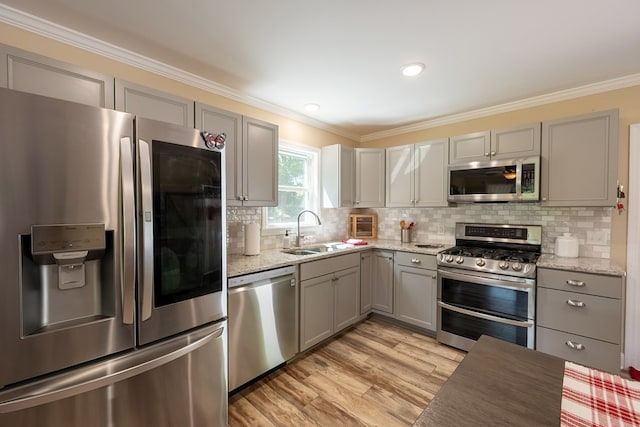1610 Pope Rd, Ivanhoe, VA 24350 - kitchen with stainless steel appliances, gray cabinets, light wood finished floors, crown molding, and decorative backsplash